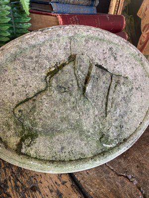 An oval cast stone plaque depicting a dog's head in profile ~C