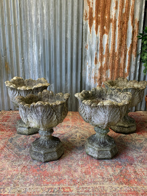 A pair of large acanthus cast stone urns