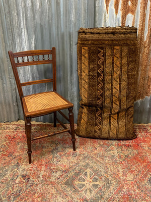 A large golden Persian carpet cushion