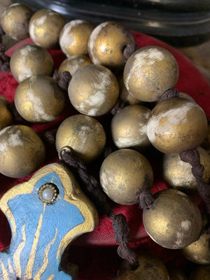 A set of oversized wooden rosary beads with eye motif