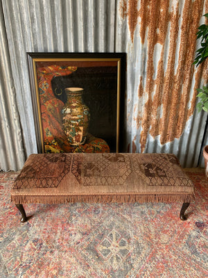 A large Persian carpet footstool