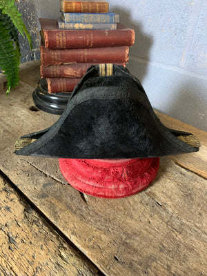 A Royal Navy bicorn hat in monogrammed tin