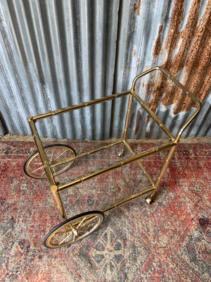 A faux bamboo Hollywood Regency two tier trolley