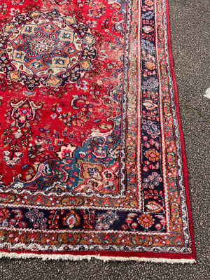 A large red ground Persian rug - 299cm x 194cm