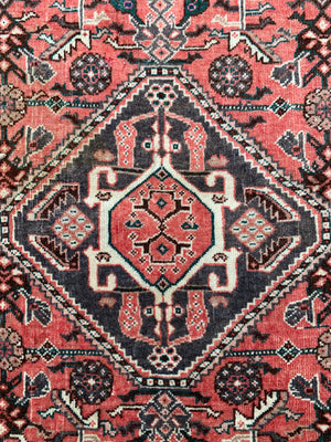 A Persian red ground rectangular rug- 161cm x 117cm