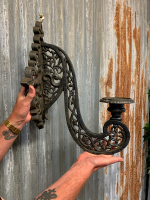 A pair of large black cast iron sconces