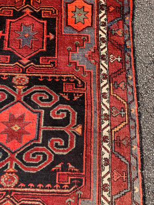 A Turkish red ground rug ~ 211cm x 138cm