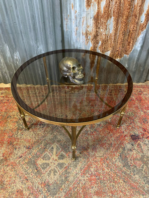 A rare circular brass and glass Hollywood Regency coffee table