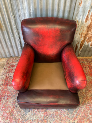 An oxblood red leather club chair