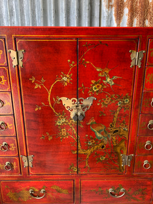 A red and gold lacquered chinoiserie cabinet