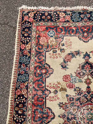 A Persian cream ground rug ~ 194cm x 133cm