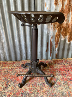 A cast iron adjustable tractor seat stool