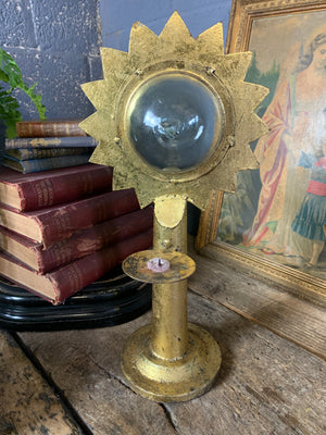 A gilt refraction candlestick with sunburst detail