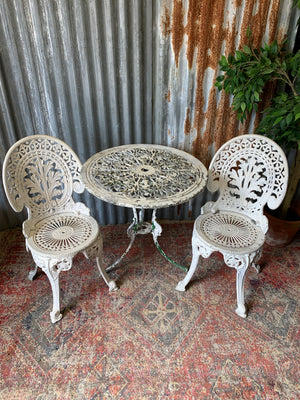 A white garden table and chairs set
