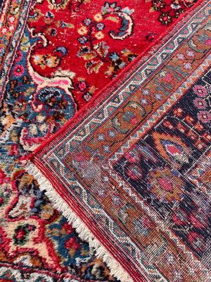 A large red ground Persian rug - 299cm x 194cm