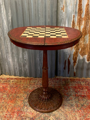 A cast iron bistro table with hand-painted chess board top