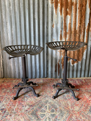 A cast iron adjustable tractor seat stool