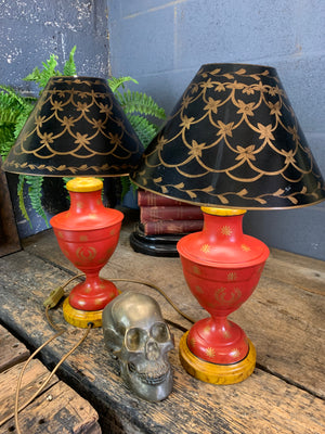 A pair of red and black toleware lamps