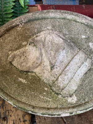 An oval cast stone plaque depicting a dog's head in profile ~B