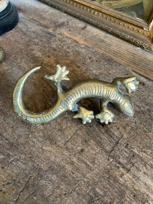 A pair of brass candlesticks in the form of lizards