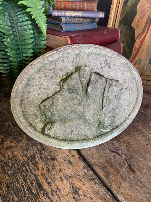 An oval cast stone plaque depicting a dog's head in profile ~C