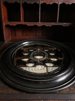 An exceptional large ebonised sorcerer’s mirror