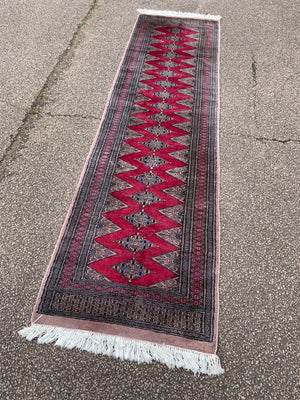 A long pink ground Persian runner rug ~ 318cm x 83cm