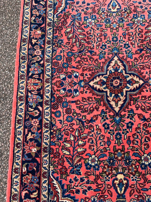 A Persian pink ground wool rug ~ 155cm x 105cm