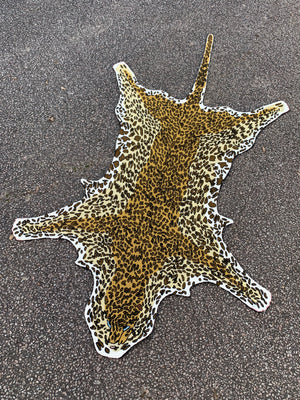 A Liberty of London faux leopard skin rug