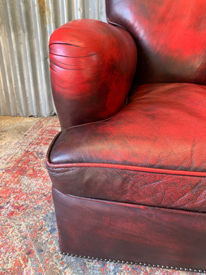 An oxblood red leather club chair