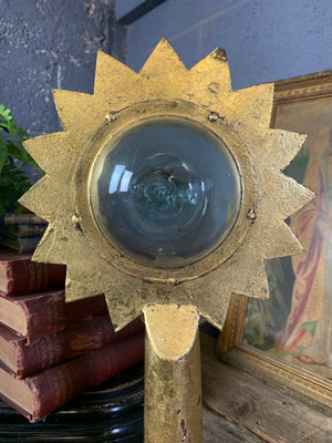 A gilt refraction candlestick with sunburst detail