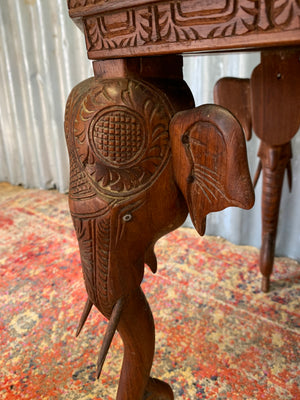 A carved wooden elephant table