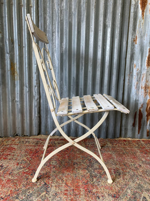 A white garden table and chairs set
