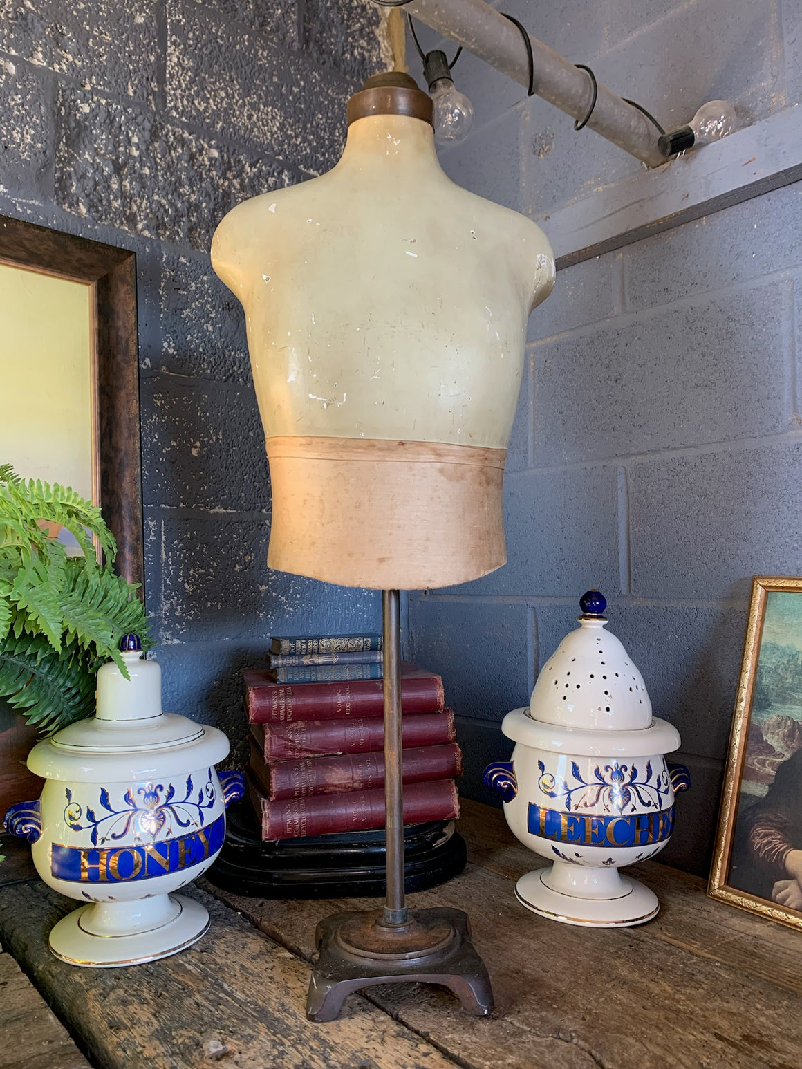 An adult male mannequin shop display model on cast iron base