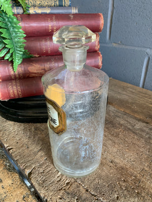 A glass "Genuine Eau de Cologne" apothecary jar