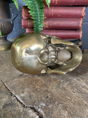 A life-size brass human skull model