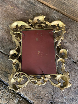 An ornate brass Rococo styled easel back mirror