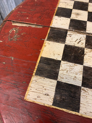 A cast iron bistro table with hand-painted chess board top