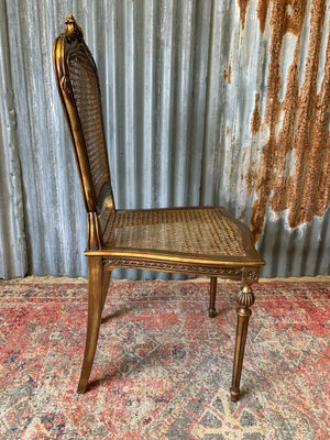 A rococo-style giltwood cane chair