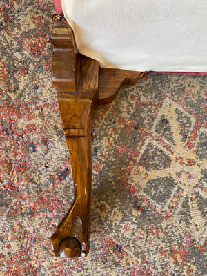 A large red velvet ball and claw footstool