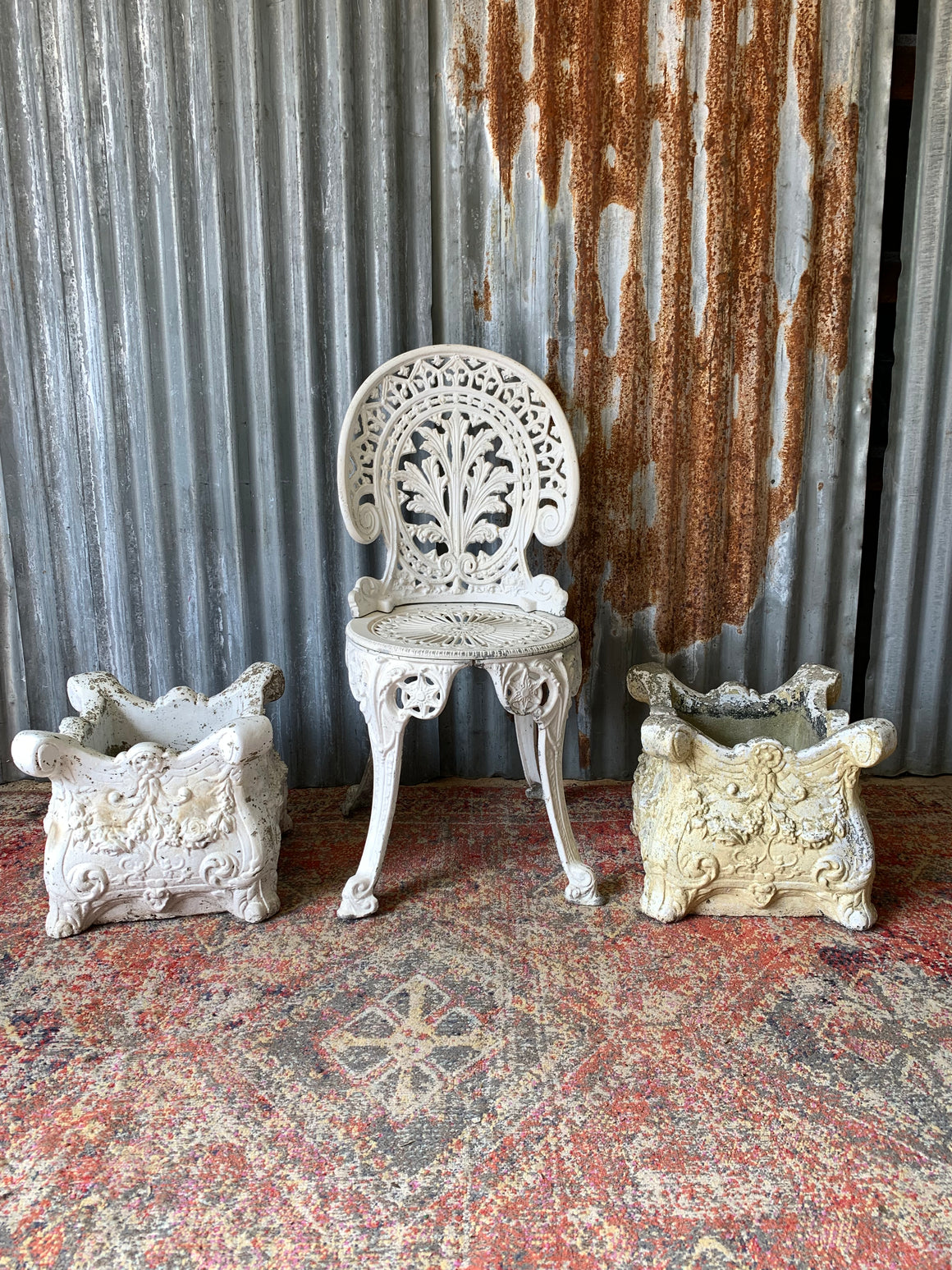 A pair of white French style cast stone planters
