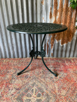 A green garden table and chairs set