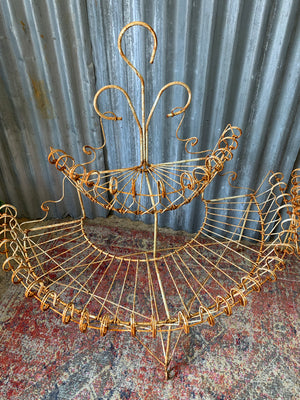 A pair of white wirework demi-lune plant stands