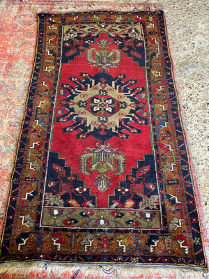 A Turkish red ground rug - 198cm x 105cm