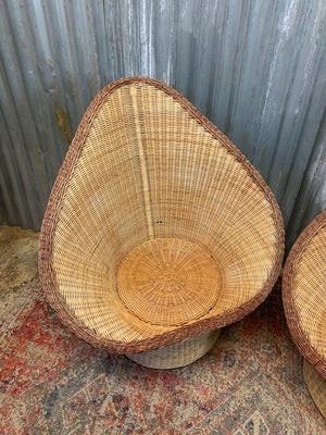 A pair of wicker egg chairs