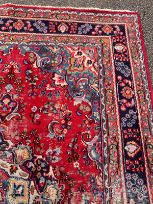 A large red ground Persian rug - 299cm x 194cm