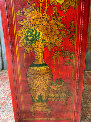 A red and gold lacquered chinoiserie cabinet