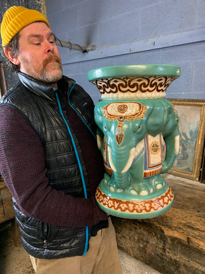 A large ceramic elephant head jardiniere