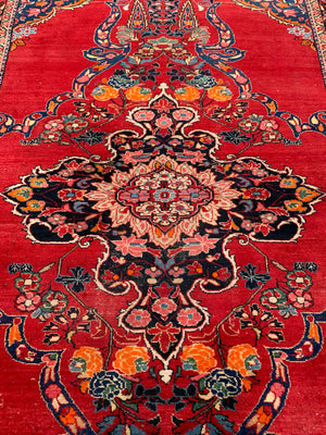 A very large rectangular red ground Persian floral rug ~ 12ft x 8ft