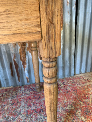 A Victorian oak table with single drawer